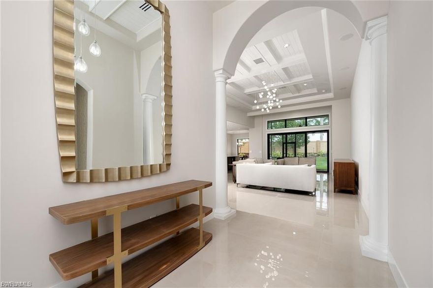 RITZ INSPIRED EXQUISITE FULL REMODEL IN SOUGHT AFTER BONITA LAKES. Luxury at its finest throughout this four bedroom, three bath custom high-end remodel. From the moment you walk in the grand arched entry with great room and crystal chandelier you will feel as if you are in a five-star resort. The entire home has been painted inside and out with sophisticated tile flooring, new sculptured carpet in bedrooms, new doors, baseboards and the finest of finishes. The great room will not disappoint for entertaining with wet bar and wine cooler leading to the designer kitchen. A butler's pantry has been added with high-end cabinetry and desk for office space off the kitchen. The designer kitchen cabinetry with interior lights compliments the eat-in kitchen with special order Imported Italian granite countertops and center island which allows for additional seating. The owner's suite has a private sitting area, plenty of room for a king-sized bedroom set and on-suite features separate bath and shower with dual sinks and walk-in closets with custom wood shelving. All new quality appliances and enough room on the oversized lot for a pool with enclosure. This home is true luxury.