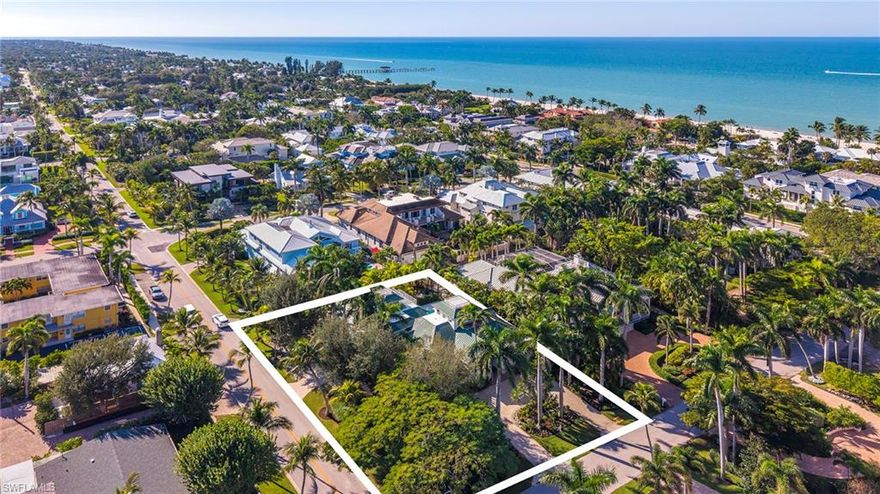 Old Florida charm meets modern sophistication in this beautifully updated Old Naples residence, located just over a block to the beach and 2 blocks to Fifth Avenue South. This 3 + den, 5 bath home offers 4,670 square feet of living area with wide-plank oak flooring, a new white-shaker kitchen with dual islands, walk-in pantry, and upgraded appliances. The spacious great room features 26-foot ceilings, custom built-ins, and an entertaining bar. The renovated owner’s suite includes superb closet systems and a beautifully appointed bath. Additional interior spaces include a study, loft with third-floor sunset terrace, and a 600-square-foot bonus room ideal for an art studio, workshop, fitness room, or flex space. The private backyard provides a serene setting with a renovated lanai, pool, oversized spa, outdoor kitchen, and southern exposure. Notable features include impact-resistant windows, 500-gallon buried propane tank powering a whole-house generator, extensive landscape lighting, fenced yard, and three garages (two rear-alley and one side-entry). Two upstairs en suite guest rooms offer balconies and generous storage throughout, including large second-floor storage closets. Move-in ready and ideally positioned to enjoy the Old Naples lifestyle.