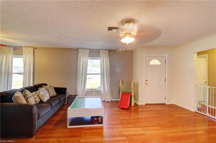 FABULOUS home for sale in the heart of Cape Coral - walking distance to St Andrews, local restaurants and ready for a new owner! Two very spacious bedrooms - home is almost 1400 square feet, plenty of room in the backyard for a pool as well!  All assessments PAID!  Beautiful hard wood flooring, tile and a very light and bright home.  Lots of money spent in remodeling - both bathrooms have been completely renovated and master bath features large walk in shower with rain head, double sinks.  Large walk in closet, beautiful planked ceiling in family room and a very deep one car garage.  Master bedroom is also spacious with crown molding - a great home for the money!