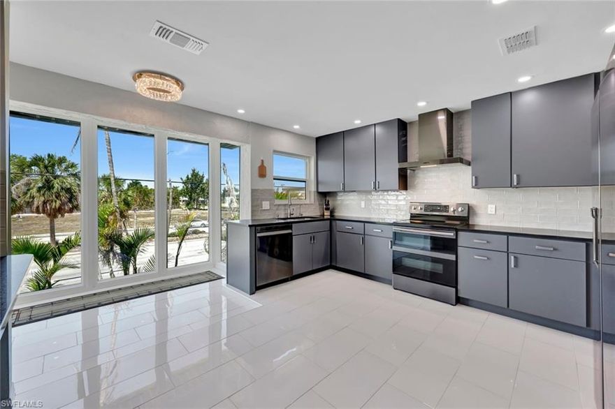 Pristine 2 bedroom, 2 bathroom condo has DIRECT SAILBOAT ACCESS, NO BRIDGES, 2nd floor unit.  The HUGE kitchen has been remodeled with modern cabinets and tile backsplash. It is only one of the only units with a vented hood.  Gorgeous sleek tile floors throughout.  Both bathrooms have been recently updated. The ENCLOSED lanai with IMPACT windows makes a relaxing and safe spot to enjoy the Florida sun. This unit has PRIVATE laundry room with washer and dryer. The seawall was completely updated in 2018 along with a new paver PATIO with dock lights.  Unit has boat slip with 10k boat lift. Enjoy the community amenities including HEATED pool with club house including BBQ area and lounge chairs. The condo has 1 assigned COVERED parking space and an outside storage closet. There are additional guest parking spaces as well.  This move-in-ready condo is in a great location surrounded by restaurants, shopping and close to downtown. No Pets