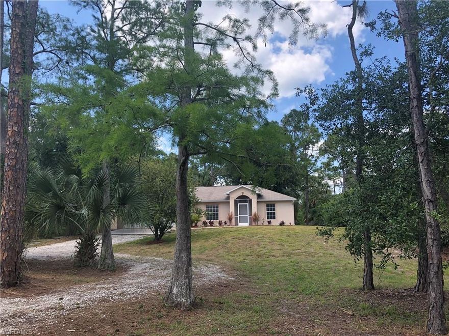 If you want your privacy, this home is for you. This property is surrounded by oak trees and beautifully landscaped. This home sits on 1.59 acre lot with a circle driveway and plenty of room to access the back of the lot. This 3 bed, 2 bath split floor plan home has it all matching dark cabinets and granite countertops throughout, freshly painted interior, updated fixtures, French door refrigerator, cathedral ceilings, a walk in closet in the master, 2 car garage with automatic opener, screened in lanai, reverse osmosis system under the sink, hurricane shutters and gutters. This home is move in ready, just unpack and enjoy...Located near Wilson and Twin Eagle Country Club just 2 minutes to the new Publix on Randall and Immokalee Rd. New AC installed by the end of 2018.