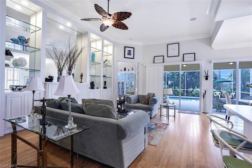 A serene oasis! This beautiful North Naples pool home has it all: crown molding; built-in bookshelves and media center; a NEW ROOF - May 2020; new A/C 2018; specialty landscaping; plantation shutters; bamboo wood flooring throughout; a cental vacuum system; new toilets 2019; new washer and dryer 2017; and freshly painted interior in  2012. The 3 bedroom / 3 bath "Oakmont" model is light and bright. It is in Island Walk, an established community on Vanderbilt Beach Rd, just minutes to all that Naples has to offer, including 8 minutes to Mercato and 10 minutes to the beach. Amenities include:  8 Har-Tru tennis courts; 4 Bocce courts; a 9 hole putting green; a bowling green; a fully equipped fitness center overlooking a beautiful lake; resort and lap pools with geothermal heaters; club house; library;town center; and miles of hiking and biking paths.