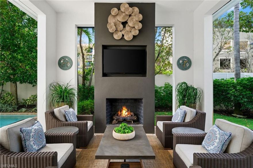 Welcome to coastal contemporary living in the heart of Naples. Perfectly located just moments from the vibrant Mercato, you can walk to some of the area’s best dining, shopping, and grocery options, while the white-sand Gulf beaches are only minutes away. This is urban coastal living at its finest.

This newer construction home offers pristine southwest and southeast exposure, filling the living spaces and saltwater pool with beautiful natural light throughout the day. A dramatic wall of sliding glass doors opens seamlessly to the stunning outdoor living area, creating the perfect indoor-outdoor Florida lifestyle.

The private lanai is designed for entertaining and relaxation, featuring a brand-new screen enclosure, cozy fireplace, TV, built-in grill, and beverage refrigerator—an ideal setting for gatherings or quiet evenings at home.

The first-floor primary suite offers a peaceful retreat with a spacious walk-in closet and a luxurious spa-style bathroom. Upstairs, two additional en-suite bedrooms and a versatile loft provide comfortable accommodations for guests or additional living space.

Additional highlights include soaring ceilings, abundant natural light, Hunter Douglas plantation shutters, automated shades, California Closets, landscape lighting, a large laundry room, dedicated planting areas, a 220-volt electric car charger, and two separate garages.

A rare opportunity to enjoy modern coastal elegance in one of Naples’ most walkable and desirable locations.

Welcome home!