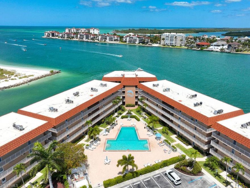 Experience the magnificence of coastal living in this newly renovated west-facing residence with highly desirable deeded dock. Immerse yourself in the meticulously designed space adorned with the finest finishes. This two-bedroom, two-bathroom residence features designer decor and premium tiling, complemented by brand new state-of-the-art appliances for modern comfort. The open kitchen boasts spacious quartz countertops and an under-counter microwave. A secluded suite with a vanishing pocket door ensures privacy for your guests. Enjoy the added convenience of a personal washer and dryer. Relax on the lanai, offering breathtaking views of Collier Creek and the Gulf. Fish from your own dock just steps from your residence or set sail on your boat and reach the beach within minutes from your private dock. Situated in the Ville de Marco West community, this beautifully appointed residence provides a tranquil haven near restaurants, entertainment, and shopping. Seize the opportunity to own this exceptional home with its recent improvements. Embrace the epitome of luxurious coastal living.