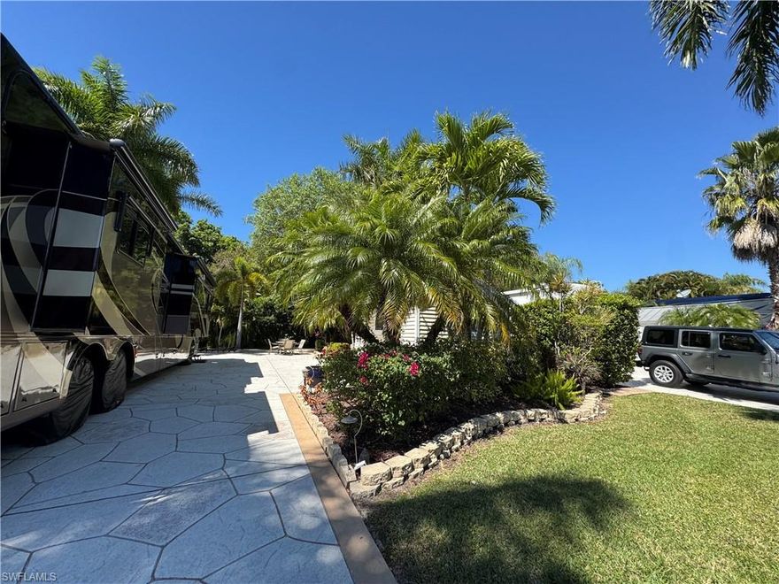 Lot 299 Your Slice of Paradise at RiverBend Motorcoach Resort. Step into the essence of tropical serenity an inviting pull in property tucked within the coveted RiverBend Motorcoach Resort. Perfectly positioned just a short stroll from the lively River Clubhouse and spirited pickleball courts, this prime location blends relaxation with resort style living. From the moment you arrive, you’ll be drawn in by the natural beauty, three regal Royal Palms and graceful shade trees draped in Spanish moss create a tranquil canopy that frames the back patio in soft, filtered light. The expanded paver patio offers an ideal retreat to unwind beneath the palms or entertain guests as the evening breeze drifts through. The coach house is thoughtfully designed for comfort and versatility, featuring a practical workspace, a cozy kitchenette, with shower, and a futon that transitions easily from lounging to guest accommodations. Mornings here are pure bliss, imagine sipping coffee as you gaze across the lush green common area that stretches before you, an open landscape perfect for morning strolls with your pup or simply soaking in the peaceful scenery. Whether you embrace Lot 299 as is, charming, private, and ready to enjoy, or reimagine it with a new, custom-built coach house, the potential is endless. At RiverBend, life moves at the perfect pace. Residents enjoy an abundance of amenities including a resort-style pool, pickleball, bocce, shuffleboard, a putting green, and a private boat ramp with easy access to the Caloosahatchee River. This pet- and golf-cart-friendly oasis radiates the warmth of old Florida charm, where days are filled with sunshine, laughter, and the camaraderie of neighbors who soon become friends. Lot 299 isn’t just a property, it’s an invitation to live the RiverBend lifestyle, where tropical elegance and genuine community spirit meet.