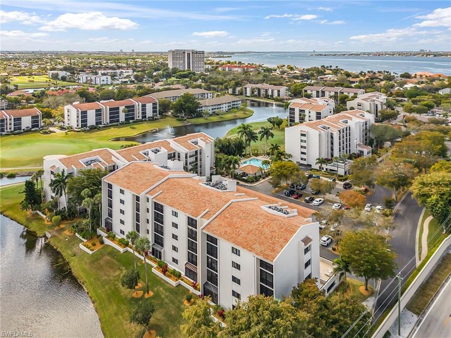 Fantastic opportunity to own your slice of paradise - this roomy end unit 2/2 condo on the plaza level overlooks a lake and golf fairway from the over-sized lanai.  Freshly painted, new plantation shutters on the impact-rated windows, newer AC and an under-building parking spot. Bonus private patio off the kitchen.  Offered TURNKEY. Very reasonable monthly condo fee, never flooded, and fully reserved. Indulge in your passions at The Landings Yacht Golf &Tennis Club!  This highly active waterfront country club community is located on the banks of the Caloosahatchee River/Intercoastal Waterway.  Enter the property from historic palm-tree lined McGregor Blvd to beautifully landscaped grounds and fantastic amenities that are included with your affordable monthly club fee.  Sharpen your skills or just play for fun on the 18-hole golf course, Har-Tru tennis courts, pickle ball courts, bocce lanes, a place for your boat subject to waitlist, the waterfront picnic area, 2 restaurants with expanded outdoor dining, clubhouse, fitness center, heated & chilled resort & lap pool, & more. See for yourself why The Landings is SW FL's best kept secret!  Make your showing appointment today.