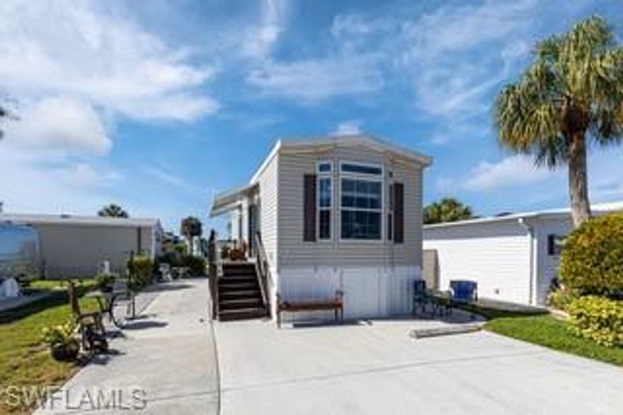 WOW! That's all I can say about this beautiful home!  Built in 2016, this home was specifically designed for the future addition of a lanai. The kitchen offers storage galore and an island. It also features soft close drawers. Dark wood floors and cabinets gives this home the look of luxury.  The water views are amazing and the bank is sloped in such a way that you can put your canoe or kayak into the water right from your own back yard.  Windows abound for lots of sunshine that southwest Florida is famous for. This home sits 72 inches above the flood plain so it leaves a lot of storage space underneath.  The back patio has a gentle breeze as you sit with your friends and visit. This one is going to go fast so don't wait to long to come see it.