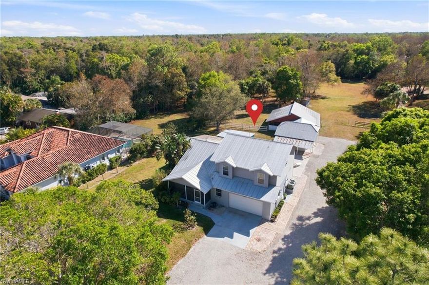 Nestled on a sprawling 2.27-acre lot, 5860 Dogwood Way in LOGAN WOODS offers the perfect blend of country charm and city convenience. This 4-bedroom, 3.5-bath home is designed with both comfort and functionality in mind. Boasting two master suites, it’s ideal for multi-generational living or hosting guests with ease. The open layout is perfect for creating memories, whether it’s a quiet family night or entertaining friends on the inviting back deck. Equestrian enthusiasts will love the well-appointed HORSE BARN featuring THREE STALLS, a spacious paddock, and ample room for your four-legged companions to roam. Adjacent to the barn, you’ll find two versatile sheds — one oversized, perfect for a workshop or man cave, and a second, smaller shed that’s ideal for a tack room or additional storage. A separate driveway to the backyard adds even more ease and flexibility. Fully fenced yard and gated entrance, all while being just minutes away from Naples’ best dining, shopping, and pristine beaches. Whether you’re looking for a private retreat, a place to grow roots, or the perfect homestead for equestrian living, this property truly has it all.