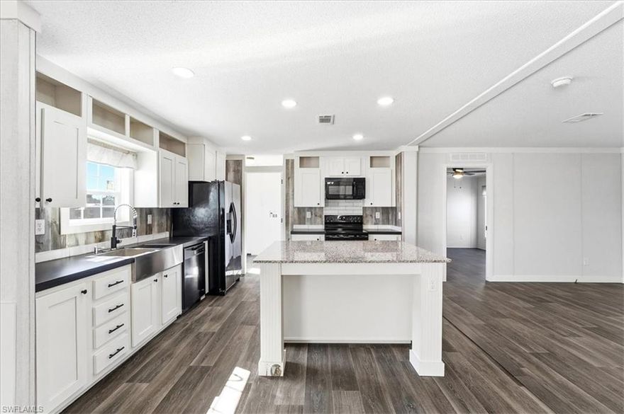 Discover the perfect blend of comfort and community in this never lived in 3-bedroom, 2-bathroom manufactured home nestled within the sought-after Old Bridge Village—a vibrant 55+ waterfront community along the Caloosahatchee River. This spacious 1,378 square foot true double-wide has brand new appliances, a new AC system, new electrical service and room for a carport. The open-concept floor plan welcomes you with stunning LVP flooring throughout and a striking accent wall featuring a cozy fireplace with mantle—perfect for relaxing evenings at home. The heart of this residence is the gorgeous kitchen, showcasing crisp white shaker cabinets and a generous island with ample storage space. Retreat to your primary suite complete with an ensuite bathroom boasting dual sinks and a spacious shower. With the home freshly elevated to meet new flood level requirements and a February 2026 Certificate of Occupancy in hand, you can move in with complete peace of mind. Beyond your doorstep awaits an active social community brimming with amenities: two heated pools, spa, fitness center, clubhouse, tennis, pickleball, bocce, and shuffleboard courts. Boating enthusiasts will delight in the deep-water marina featuring 81 slips with direct Gulf access. Enjoy nearby Powell Creek Preserve for nature walks, convenient access to the NFM Library, and proximity to Fort Myers Downtown Commercial District for shopping and dining adventures. Added Bonus - Opportunity to purchase the lot and a simplified closing via title transfer. Your Florida paradise awaits!