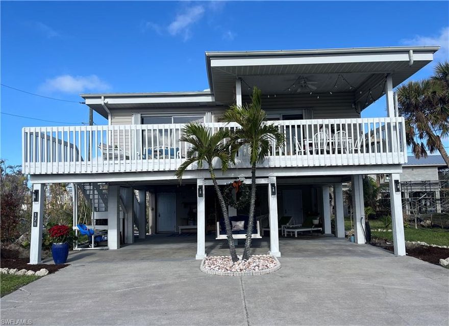 SELLER RELOCATING - PRICE REDUCED - BRING OFFERS!  Welcome to 171 Lanark Avenue, a charming beach retreat nestled on Fort Myers Beach, FL. Step back in time and embrace the timeless allure of a vintage Florida beach home. This delightful home offers 2 bedrooms and 3 bathrooms, spread across 1,100 square feet of thoughtfully designed living space. Situated on a generous 75 x 120 foot lot, this property provides ample opportunities for expansion, whether you're considering a charming addition, major new construction, or even a pool. This spacious lot allows for creative possibilities to enhance your living experience, making it an ideal choice for those looking to customize their beachside retreat. Enjoy peace of mind because of a new roof, new HVAC system, and new electrical upgrades to include a circuit breaker box and meter. The newly installed in-ground sprinkler system ensures green surroundings year-round. Step inside to discover a home with new LVP (Luxury Vinyl Plank) flooring throughout, complemented by new ceiling fans and freshly painted white walls that create a bright and inviting atmosphere. The living area is located on the second level, where you can take in breathtaking views of the beach and the Gulf of Mexico from the living room and your private deck. The main level features a separate laundry room and storage area, which was previously a studio apartment and can be easily converted back if desired. Both of these functional spaces are conveniently located within the two-vehicle carport area, providing practicality and versatility to suit your needs. This property is perfectly positioned for those seeking the ultimate beach lifestyle as it's just steps across Estero Blvd to the sandy shores of Fort Myers Beach. You'll also find your home surrounded by newly constructed multi-million dollar homes, enhancing your property's appeal and value. With no HOA fees, you have the freedom to make this home truly your own. Located mid-way on Estero Island, you're an inviting distance to Times Square, restaurants and the new Margaritaville Resort, as well as just a mile from local conveniences like Publix, 7-Eleven, and CVS. Furthermore, just a leisurely 30-minute drive from Naples to experience the delightful restaurants, elite shopping and other attractions. Whether you're looking for a permanent residential property, a vacation getaway, or an investment property (for the last 4 years, the owner has been a Superhost with Airbnb), 171 Lanark Avenue offers endless possibilities for enjoying the Florida sunshine and stunning sunsets. Don't miss the chance to make this adorable beach house property your own slice of paradise!