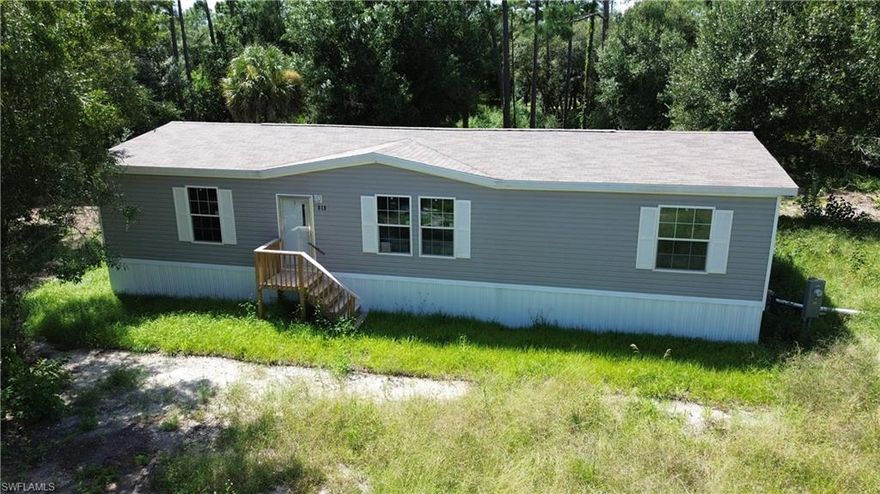 Welcome to Montura Ranch, Woodlands Subdivision. This is a rural gold-cart and horse-friendly community with NO HOA's. New Construction includes a 1,493 sq ft 2024 DWMH Champion Model 26.8 x 56 with 3 bedrooms and 2 baths. All New septic, well and underground electric wiring sitting on 1.03 acre. Beautiful color scheme and trimming through the house with laminate flooring. Stainless Steel Appliances. Fully furnished. Washer/Dryer Hookup. This home qualifies for USDA, FHA AND VA lending. Enjoy the peaceful country farm life near the entrance of Montura Ranches, 20 min out of town. Call to schedule your showing today!