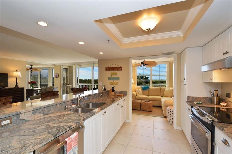 Just Reduced! Lowest priced 2+den with Gulf view in Pelican Bay! Ready to enjoy, bright 4th floor (building 5th floor) 02 has been extensively updated and used only for vacations! Professionally decorated, with "opened up" kitchen including new GE stainless appliances, granite countertops, new tray ceiling/lighting. You'll love the coastal ambiance of new whitewashed wood floors in both bedrooms and recent 20" porcelain tile in the living and wet areas (no carpet!), as well as plantation shutters complimenting new baseboards and crown molding.  Choose GORGEOUS sunsets/Gulf vistas from the slider-enclosed porch (currently enjoyed as dining room) OR from the spacious open balcony, or living area! This floorplan with opened slider-enclosed porch adding to the living area affords lots of flexibility to suit your lifestyle.  AC replaced in 2015 (Carrier).  Guest suite has privacy pocket door and walk-in closet.  St. Marissa offers an updated lobby, huge renovated social room w/ full kitchen, large sunny pool/spa, updated fitness room, 2 updated guest suites, billiards room, bike storage, full-time onsite manager and excellent maintenance staff.  Easy beach access via tram or walking.