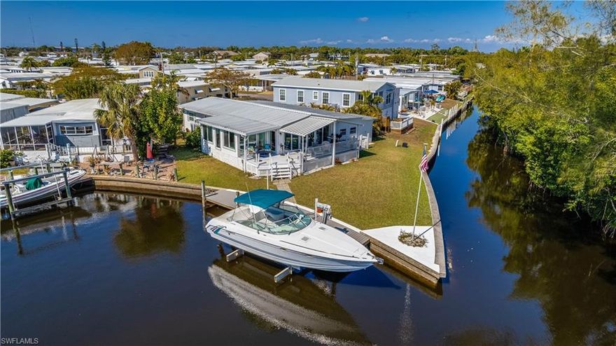 Beautifully furnished waterfront home situated on a corner lot with desirable southern rear exposure and direct Gulf access with no bridges. Boaters will love the new private dock and lift (2023/2024), making days on the water effortless. This light-filled home features impact windows and sliders, French doors, crown molding in main living areas, recessed lighting, custom blinds, stainless steel appliances, and indoor washer/dryer. Major updates include a new roof (2022) and new A/C (2022). Watch the boats go by on your private deck area. Large shed/workshop offers excellent storage or hobby space and includes additional washer/dryer hookups and electrical. Ideal for those seeking low-maintenance waterfront living with outstanding boating access and lots of amenities including community pools, spa, boat ramp, docks, pickleball, shuffleboard, community room, and so much more!