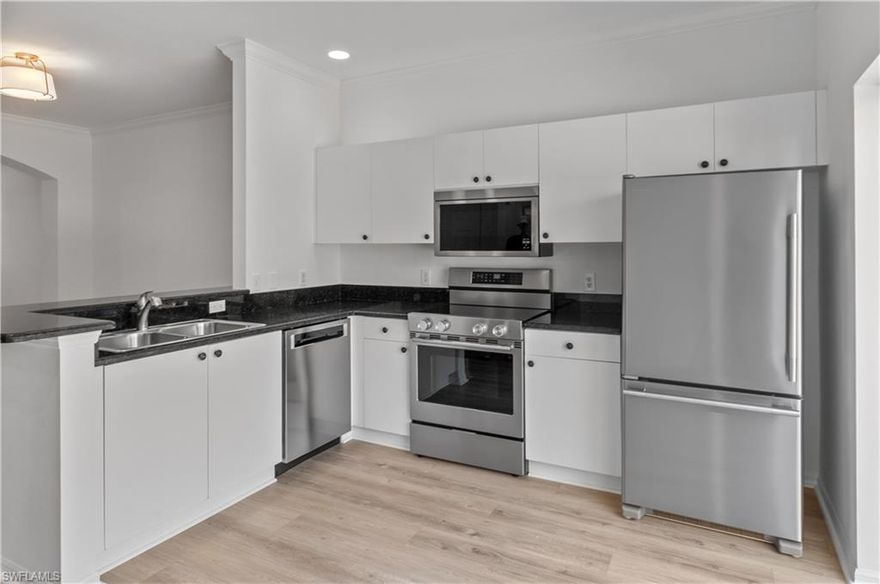 Beautifully updated 3 bedroom 2.5 bath townhouse in a terrific location. Easy access to the beach and I-75. New luxury laminate throughout. New High end Kitchen Aid appliances. New light fixtures. Freshly painted, high ceilings, crown moldings. Relax on your deck overlooking the preserve. Master bedroom with ensuite, another bedroom has its own balcony, the third bedroom would be a perfect office or guest room. HVAC 2022. Low quarterly dues. One car garage, freshly painted and new epoxy floor. Two community pools, with one steps away from your condo. Pets allowed to 40 lb. maximum.