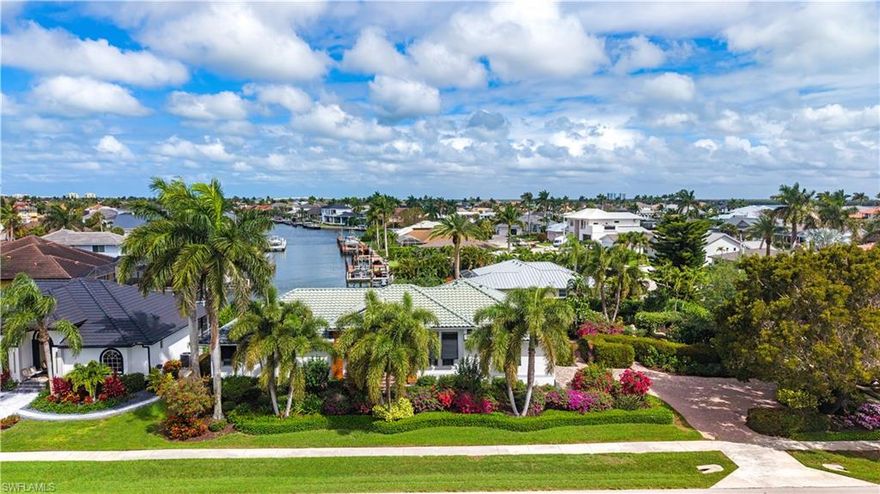 Seize this rare opportunity to own an exquisite water-direct home in one of the most sought-after paradises! This stunning property, proudly recognized as a Marco in Bloom award winner, offers breathtaking long canal views and a private zen garden nestled on an oversized corner lot, perfect for those who appreciate both beauty and serenity. Step into this expansive 3-bedroom plus den, 2-bathroom residence that perfectly blends elegance and comfort. Designed for the discerning homeowner, this layout promises an abundance of space for family living and entertaining. The spacious den serves as a versatile area—perfect for a home office, a cozy reading nook, or an additional guest room. Experience the tranquility of your own private retreat. The centerpiece of this lush haven is a beautifully landscaped fenced courtyard, featuring a stunning travertine stone sitting area where you can unwind and soak in the peaceful surroundings. A charming stone path meanders throughout the garden, inviting you to explore every corner of this green sanctuary. Luxurious Master Suite -Indulge in the lavish master suite that boasts an impressive walk-in closet and a spa-like bathroom designed for relaxation. Enjoy a rejuvenating soak in the luxurious walk-in tub, complemented by two exquisite Mavisever 36 x 36 LED mirrors that add a touch of glamour to your daily routine. This home is an entertainer’s dream! The expansive lanai provides an ideal space for hosting unforgettable gatherings with friends and family. Picture yourself enjoying leisurely afternoons by the sparkling pool, which features a newer travertine deck and a soothing spa, all set against the backdrop of your private waterfront paradise. The immaculate garage features a durable epoxy floor, along with ample shelving and cabinets, ensuring you have plenty of space for all your gear and recreational equipment. For the avid fisherman or boating enthusiast, the property includes a well-appointed dock with a fish cleaning station, making it easy to enjoy the best of waterfront living. The lanai is enclosed with a 45’ picture frame cage, enhancing your outdoor experience while keeping insects at bay. Additionally, a newer generator with dual 175-gallon propane tanks ensures peace of mind during power outages. Enjoy year-round swimming with the newly installed Wi-Fi-controlled pool heater, allowing you to set the perfect temperature at your convenience. This home is more than just a property; it’s a lifestyle. From the meticulously designed landscape to the luxurious interior features, every detail has been thoughtfully curated to provide an unparalleled living experience. Imagine waking up to stunning views, basking in the sun by your pool, and savoring the serene ambiance of your private garden oasis. Don’t let this incredible opportunity slip away! Properties of this caliber are rare to come by and are in high demand. Your dream tropical paradise is just a call away—act quickly to make it yours! ????