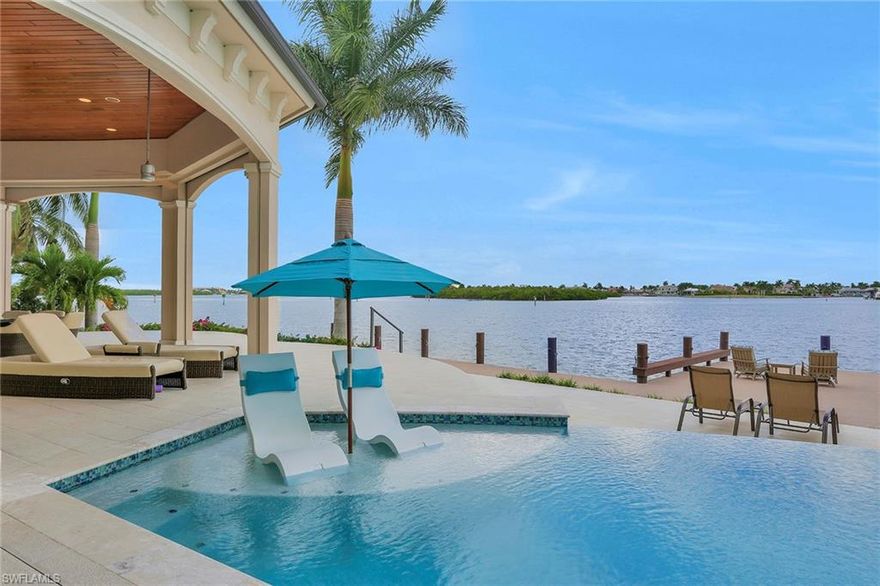 This spectacular Coastal Contemporary home, with jaw dropping views from every room, sits on a tip lot in the prestigious Tigertail area of Marco Island. Boasting 173’ on water direct built in 2015. This magnificent estate will take your breath away from the moment you walk in! This 2-story custom built home is well appointed with marble and tile floors, soaring 15’ ceilings, with incredible craftsmanship throughout, completes this lavish interior space!  With over 4800 SF under air this 4Bd/4.2Baths, has a huge great room, den, and upstairs media room with wet bar.  Custom gourmet kitchen includes quartz counters and Thermador appliances, offering stunning views from every window!  Impact doors and windows complete with electric storm shutters and screens.  A true boaters delight, seconds to open water, boasts jet ski and boat lifts with wrap around deck. The outdoor living space has multiple entertaining areas, an outdoor kitchen, centered around the infinity edge pool and spa!  Built for the most discerning buyer, this home has it all!  Being sold turnkey furnished!
