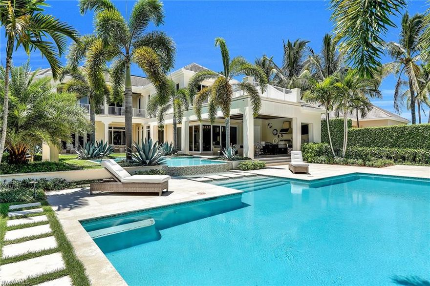 Tastefully designed with meticulous craftsmanship, this exquisite waterfront estate embodies the Port Royal lifestyle. Encompassing 7,638 square feet under air, this five-bedroom, five-and-two-half-bath coastal home captivates you the minute you enter. Wide plank wood floors, custom moldings, a stunning dream kitchen with Sub-Zero, Wolf and Bosch appliances and an open sun-filled floor plan show that no detail was overlooked. The first-floor master suite has a luxurious spa-like bath and sitting area that overlooks the pool area. The upstairs boasts a VIP suite with a large luxurious bath and a private sundeck that enjoys views of the pool and Runaway Bay. Whether enjoying quiet relaxation or resort-style entertaining, the gorgeously designed oversized pool, fountains and spa are a perfect oasis of beauty. With a covered summer kitchen, lovely manicured lush landscaping and two docks for the boating enthusiast, the outdoor area is truly spectacular. Other features include additional second-floor laundry, camera-monitored security, LED lighting, ELAN G automation, retractable screens and storm shutters and an oversized three-car garage. Port Royal club membership eligible.