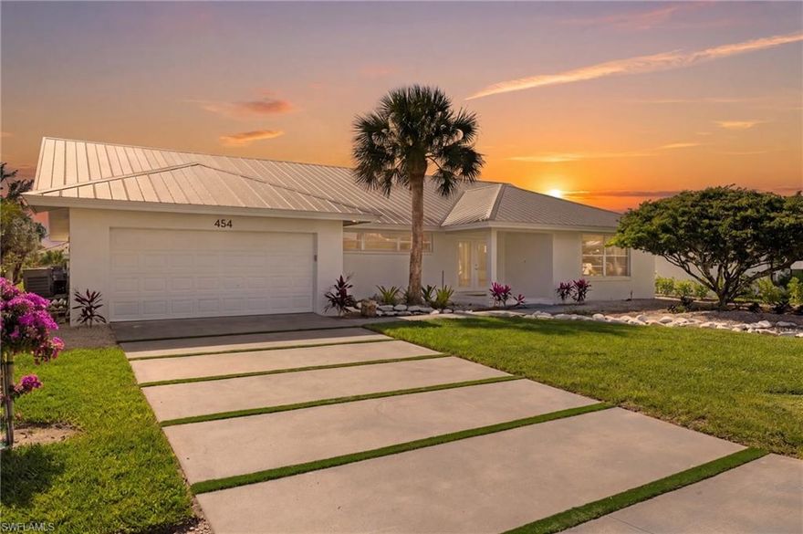 RARE OPPORTUNITY—canal-front living on a lot with coveted southern exposure and in a X500 flood zone, meaning NO FLOOD INSURANCE REQUIRED and a history of NO HURRICANE DAMAGE. For the savvy buyer, this is a property built around flexibility and upside—you can live in it while designing and building your future dream home, or buy and hold while continuing to operate it as a short-term rental as you plan your next move on this premier waterfront parcel. The updated 2-bedroom, 2-bath residence is fully livable and turnkey today, allowing immediate enjoyment while still preserving long-term development potential in one of Naples’ most desirable canal-front locations. Soaring 20 ft ceilings and an open, light-filled layout create an immediate impression, with natural light moving throughout the home and enhancing the sense of space in every room. Ideally situated just minutes from Wiggins Pass State Park and Vanderbilt Beach, offering quick access to pristine Gulf beaches, boating access, and outdoor recreation. This is a strategic Naples acquisition where you control the timeline, use, and long-term vision. The dwelling is currently being used as a short-term rental, and the management company would continue maintaining and renting the property, if desired.