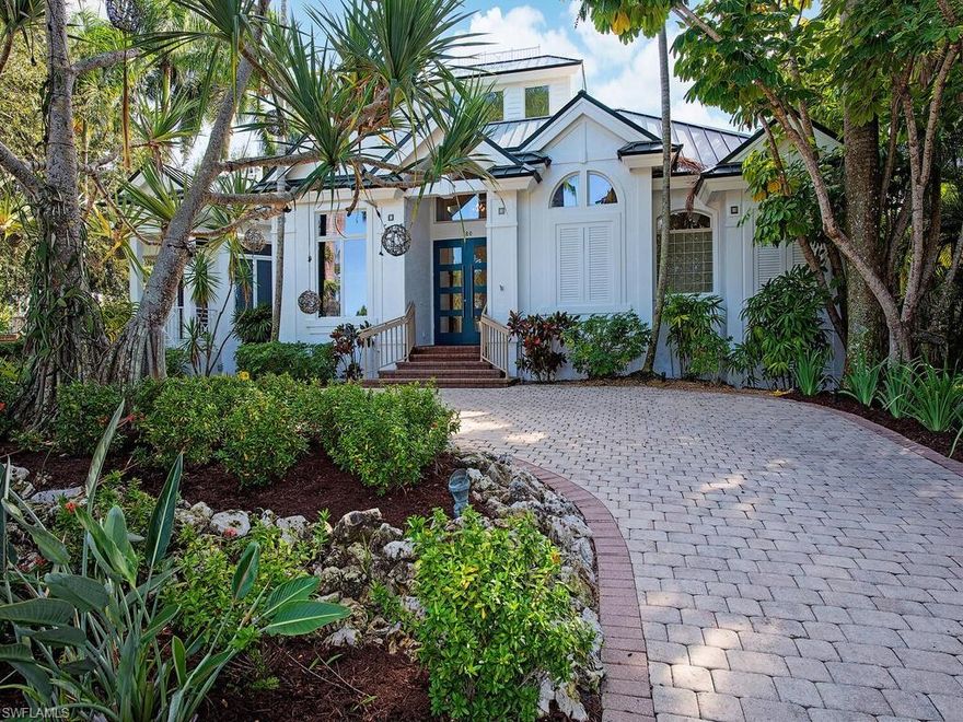 Old Florida charm meets modern sophistication in this beautifully updated Old Naples residence, located just over a block to the beach and 2 blocks to Fifth Avenue South. This 3 + den, 5 bath home offers 4,670 square feet of living area with wide-plank oak flooring, a new white-shaker kitchen with dual islands, walk-in pantry, and upgraded appliances. The spacious great room features 26-foot ceilings, custom built-ins, and an entertaining bar. The renovated owner’s suite includes superb closet systems and a beautifully appointed bath. Additional interior spaces include a study, loft with third-floor sunset terrace, and a 600-square-foot bonus room ideal for an art studio, workshop, fitness room, or flex space. The private backyard provides a serene setting with a renovated lanai, pool, oversized spa, outdoor kitchen, and southern exposure. Notable features include impact-resistant windows, 500-gallon buried propane tank powering a whole-house generator, extensive landscape lighting, fenced yard, and three garages (two rear-alley and one side-entry). Two upstairs en suite guest rooms offer balconies and generous storage throughout, including large second-floor storage closets. Move-in ready and ideally positioned to enjoy the Old Naples lifestyle.
