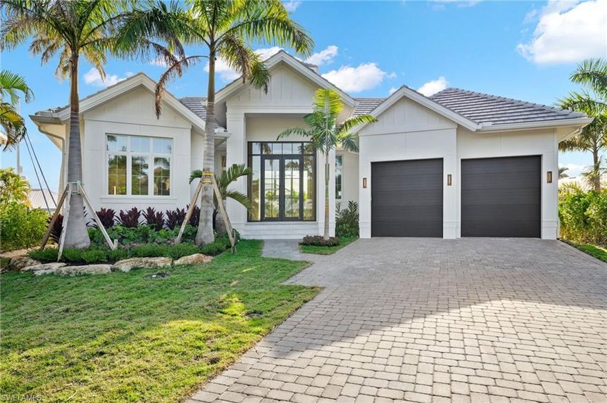 Just completed 2024 new construction home ready to move in!  Certificate of Occupancy just issued by city of Naples.  Home is actually listed below the Zillow Estimate! Immediate equity!  Discover the allure of 1675 Mullet Court in the sought-after Royal Harbor location. This waterfront haven, boasting 4 bedrooms plus den and 4.5 baths, is a collaborative masterpiece by the esteemed architect Falcon Design and local home builder GWB is ready to move into and enjoy for season!  City of Naples Certificate of Occupancy just issued.
Step into the inviting entry foyer, where soaring ceilings guide you to a spacious Living Room. Access to an outdoor living area with a 60" linear fireplace seamlessly blends indoor and outdoor spaces through expansive walls of glass. The stunning pool, complete with a sun shelf and spa, is surrounded by marble decking, providing a captivating view of the 138 ft of corner canal footage, new seawall, and dock.
The Chef's Kitchen showcases Thermador appliances, including a commercial-grade 48" range, 48" refrigerator, beverage refrigerator, ice maker, custom cabinetry, quartz countertops, and an oversized 15 ft island. For the ultimate entertainer, a separate prep/catering kitchen with refrigerator and dish washer and a walk-in pantry awaits. Step outside to your outdoor kitchen and dining area, featuring electronic screens that overlook the canal. The primary suite oasis comprises a spacious bedroom, den, and a spa-like En-suite Bath with an oversized shower, freestanding soaking tub, separate vanities, water closet, and a walk-in closet.
With 3 additional guest suites, this residence is truly exceptional—crafted to perfection and offering a luxurious lifestyle beyond compare.