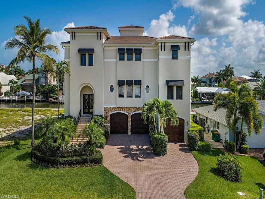 This Conners waterfront estate has everything the discerning homebuyer can ask for.  Immaculately maintained and recently renovated to the highest of standards.  Open floor plan with natural sunlit rooms embrace you upon entry into the dramatic foyer with soaring 30 foot ceilings.  This house is perfect for entertaining guests with large open spaces, multiple outdoor and open balconies and a first floor game room, bar and entertaining area that spills out onto the lanai with your private pool and spa overlooking your covered boat dock resting on the canal.  This true tropical paradise embraces the Naples lifestyle of happy and healthy living. The kitchen has double island with waterfall countertops, custom wood cabinetry and oversized stainless side by side refrigerator and freezer.  The master suite has his/her closets with custom built mirror and glass cabinetry, a walk-out balcony and large open bathroom. There are 5 professionally decorated guest rooms boasting water vistas from every window. Conners at Vanderbilt Beach is  the Gold Standard for North Naples waterfront living located 1.5 miles to Vanderbilt Beach, provides quick Gulf of Mexico boating access.