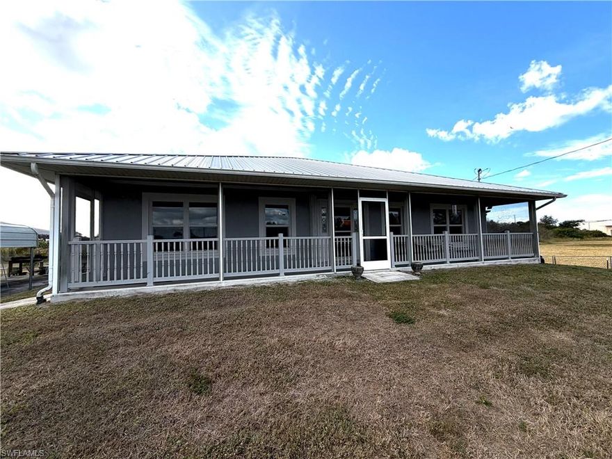 PRICED BELOW RECENT APPRAISAL and NOT IN A FLOOD ZONE. CUSTOM-BUILT single-family home situated on a sprawling 1.26-acre fully fenced lot, offering privacy, flexibility, and room to live the lifestyle you want. If you are looking for acreage with a country feel, yet still want to be in close proximity to city living, this is the home you’ve been looking for. This 3-bedroom, 2-bath residence features nearly 2,100 sq ft of living space, plus screened front and rear lanais and an open patio area, perfect for both everyday living and entertaining.

A standout feature of this property is the detached 24x24 garage, accommodating two vehicles and offering a built-in workshop area, along with a 12-ft carport extension for two additional vehicles. The garage is equipped with 240V and 50-AMP service, and the side RV port makes this home ideal for RV owners or Tesla charging. A whole-house solar system keeps energy costs exceptionally low (average electric bill approximately $25/month; paid off by the seller at closing.

The home is designed for efficiency with blown attic insulation and a foil radiant barrier beneath the trusses to reflect heat. Additional improvements include impact windows, shutters for door openings, city water, and a metal roof installed in 2018.

Inside, you’ll find a generous great room with wood-look flooring, vaulted ceilings, and sliding glass doors opening to the rear screened lanai. The large eat-in kitchen features a large island with a Jenn-Air cooktop (grill, downdraft, and four burners), wall oven, pantry, tile backsplash, an abundance of hardwood cabinetry, expansive counter space, and a massive breakfast bar.

The primary suite offers two closets, double pocket doors leading to a private bath with an impressive 9-ft walk-in shower, and pocket sliders that open directly to the rear screened lanai. Both guest bedrooms are spacious enough for king-size beds, and the guest bath includes a tub/shower combination. Additional conveniences include an interior laundry room with utility sink and a central vacuum system.

Zoned AG, this property allows for horses and other agricultural uses, making it ideal for those seeking equestrian or hobby-farm lifestyle (buyer to verify specific uses). Outdoors, there is irrigation installed for a home garden area (located to the left when facing the home and outlined by brick), plenty of room to add a pool, and wide-open space to enjoy Florida living. Calling all pilots! This home is within walking distance to Pine Shadow Air Park, making it an exceptional opportunity for aviation enthusiasts. For those drawn to an equine lifestyle, a nearby 2,000-acre horse park offers trails and expansive green space. 

Conveniently located near shopping, dining, and grocery stores, with easy access to I-75, and just off N Tamiami Trail and Del Prado Blvd N, this property delivers the perfect balance of space, efficiency, lifestyle, and location. At this price, it's time to MOVE!