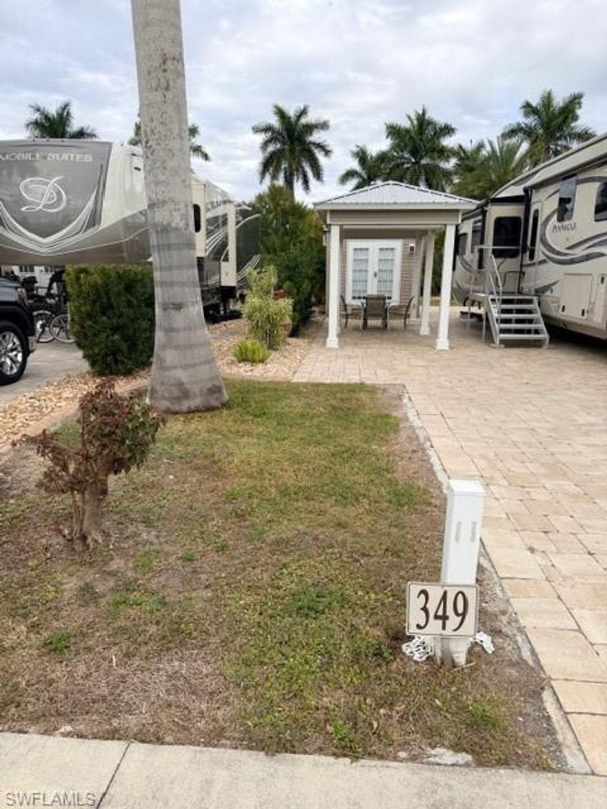Lot 349 located in Cypress Trail RV Resort is a South facing completely paved lot.  On this lot is a  very large Amazon built Gazebo that is10x12’ in size and has twin ceiling fans under the awning as well as numerous additional outlets.  This Gazebo will offer you additional shade and some protection from the Florida sun.  There is also a 10 x 12‘ Amazon shed, hurricane strapped  down and complete with a jack knife Sofa sleeper, a full-size LG washer and dryer with a direct drive easy reach smart drum sensor and drive diamond glass dryer.  You will enjoy the warm water coming from your on demand Rheem performance electric  water heater as well as a sink and a toilet with additional storage above the toilet.  There is twin doors that are double blinded and allow greater access for moving furniture in and out of the shed.  This lot is only a few minutes from the Clubhouse, Pickleball and Tennis courts, Shuffleboard and Bocce Ball courts and if you’d like to play Bags also known as Corn Hole it is available once a week as a group activity.  If you have any dog(s) you can take your dog(s) out on the grass behind your lot or walk over to the dog park that is only a few moments away.  Your soon to be lot is lined with ample vegetations from your yew plum Pines, miniature date plum, song of India plants and additional landscape  stone covering with irrigation.