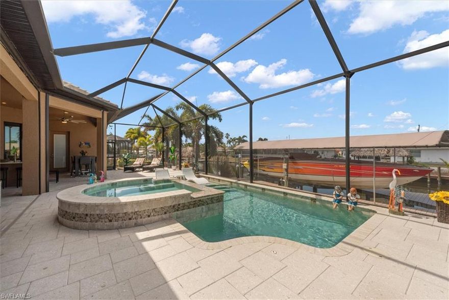 Welcome to an exceptional waterfront residence in the highly sought after Cape Coral Yacht Club District, one of the most prestigious boating locations in Cape Coral. Built in 2016, this stunning one owner custom home offers 2,622 square feet of beautifully designed living space with three bedrooms, three bathrooms and an ideal layout that includes both luxury primary suite and private mini suite for guests. From the moment you arrive, the home makes a statement with impressive 10-foot steel entry doors elegant paver driveway and a spacious three-car garage equipped with its own mini-split system. Inside residence showcases beautiful tile flooring throughout, soaring ceilings and a bright, open floor plan designed to maximize natural light and waterfront views. The Chef's kitchen is a true showpiece, featuring custom cabinetry and premium Sub Zero Wolf and Blue Star appliances, Wolf Induction Range Top, Wolf Built-In Coffee System, Sub Zero Built-In Refrigerator, Bosch Dishwasher-making it perfect for both everyday living and entertaining. Boating enthusiast. This property is a dream come true. Located just five minutes from open water. The waterfront setup includes a 13,000 pound boat lift and a durable trex dock that runs the entire length of property-providing ample space for relaxing, fishing, or docking your vessel. This extraordinary property combines luxury, location, and boating convince in one of Cape Coral's most iconic waterfront neighborhood.