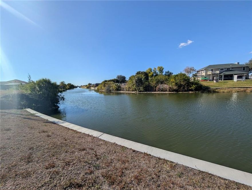 Discover the perfect location to build your dream home on this slightly oversized waterfront lot in beautiful Cape Coral. Situated on a freshwater canal, this property offers stunning water views due to its "V-view" down the canal. The lot features a brand-new seawall, saving you significant construction costs and giving you a head start on building. With extra space compared to standard lots, you'll have more flexibility for your home design, landscaping, and outdoor entertaining. Located in a growing area of Cape Coral, this property offers easy access to shopping, dining, schools, and all the amenities Southwest Florida has to offer. This area of Cape Coral is already connected to city water, so no need to install a costly well system! Whether you're planning to build now or invest for the future, this waterfront homesite is a fantastic opportunity. City water is already in place so no need to build a costly well! Don't miss your chance to own a piece of paradise with wide canal views, and a new seawall already in place.
