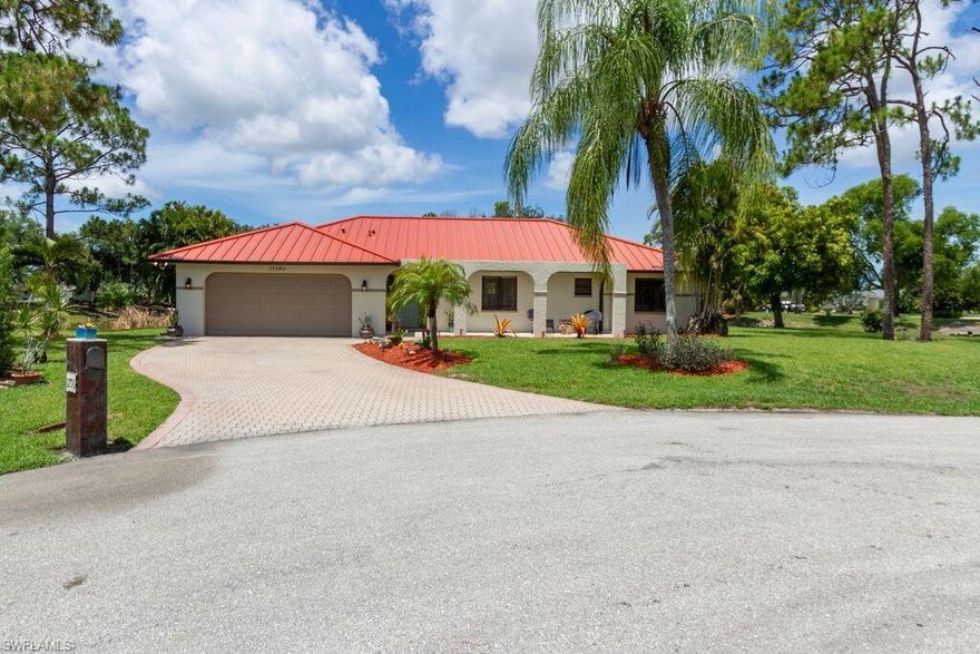 Beautiful single family home with 3 bedrooms, 2 and 1/2 baths and 2 car garage.  Private and serene back yard with large covered lanai and screened in pool overlooking a lake and gorgeous sunsets.  Kitchen with granite counters, stainless steel appliances, and pantry overlooks the pool and large dining room. Spacious family room with volume ceilings with sliders overlooking the pool area.  Owners bedroom with en suite bath and walk-in closet. Diagonal tile throughout the entire home, in-home laundry.    Large front patio with travertine flooring. New metal roof, and gutters, new exterior paint, paver driveway, sprinkler system on well, and room to store your boat!  Large half acre lot on a cul-de-sac in a very convenient area of Bonita Springs west of I-75 off of East Terry.