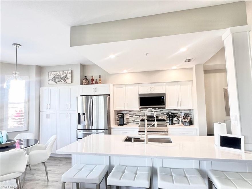 This beautiful totally updated 2 BR / 2 bath Brookside model condo is located in the desirable gated BUNDLED GOLF community of Naples Heritage Golf & Country Club. (Golf membership included) This spacious condo offers 1,232 sq. ft. of living space and is being sold turnkey! Residence is located on ground floor thus offering the conveniences of no stairs to climb or elevator to wait for, a storage room located just across from unit and an assigned covered parking space steps away.  Floor plan is open concept making it perfect for everyday living as well as entertaining. Upon entry you are greeted with all new luxury vinyl flooring thru out the unit, arched entryway into the main living area and abundance of natural light. 
The Kitchen has updated shaker cabinets, quartz countertops, large Kraus stainless steel workstation sink and top of the line Samsung stainless steel appliances. Custom built shaker pantry with slide out drawers. Seating for 5 in kitchen and seating for 4 with matching bar stools at Quartz counter top.
The dining room includes a Hamilton Buffet with a hidden queen size Murphy bed for when your guests come into town and a matching desk to get your work done.
Livingroom has high end furnishings including Stressless power recliners and 65 inch LG Picture Frame TV and Sonos sound system. 
Spacious primary suite offers beautiful Alf Italian furniture, new king size Beautyrest Black series mattress, Samsung 55” wall mounted tv and an updated bathroom with a shaker vanity and double sink quartz countertop. 
Guest bedroom has new Tommy Bahama queen size pillow top mattress.
Screened lanai with new Weber Electric grill where you can enjoy relaxing and/or dining while taking in the serene view of golf course, lake and preserves. 
See attached list of all improvements and updates the current owner has done.
This Unit is conveniently positioned in close proximity to satellite pool and within walking distance to clubhouse. Naples Heritage Golf & Country Club features an 18 hole championship course, newly renovated driving range, putting green, resort style pool with cabana bar and grille, state-of-the-art fitness center with trainers, 6 tennis courts, 4 pickleball courts and a clubhouse that offers golf pro shop, diverse dining options and a social calendar full of events and activities. Whether you're an avid golfer or simply looking to enjoy resort style living youll love Naples Heritage. Naples Heritage just 10 minutes from downtown 5th Ave dining/shopping & pristine beaches.