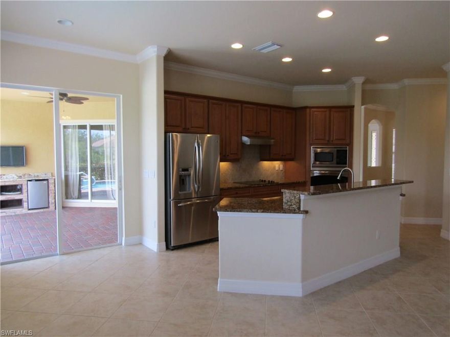 BACK ON MARKET, CONTRACT FELL THROUGH! Do not make your buying decision until you see this exceptional property! Now FRESHLY PAINTED and NEW CARPET in all the bedrooms! Over 2600 sq ft of luxury in this 4/bed 2.5 bath home, starting with a spectacular kitchen w/upgraded cabinetry, stainless steel appliances, granite countertops & a single-basin sink! Also 18" tile on the diagonal in the public areas & baths, tray ceilings in the Living Room & Master Bedroom, in-ceiling speakers for surround sound and Crown Molding throughout! The Master has beautiful cabinetry & granite, a frameless shower enclosure and wonderful "California Closet-style" built-ins! And as much as you'll want to enjoy the inside of this beautiful home, just WAIT until you see the outside! The lanai area rivals homes at WAY-higher price points than this! From the screened solar-heated pool & spa w/paver decking, to the extensive custom outdoor entertaining area featuring a granite OUTDOOR KITCHEN and separate granite Dry Bar & Fridge area with an incl. wall-mounted TV! Superb, desirable lot w/LONG LAKE VIEWS & the privacy of the preserve behind you. A GEM!