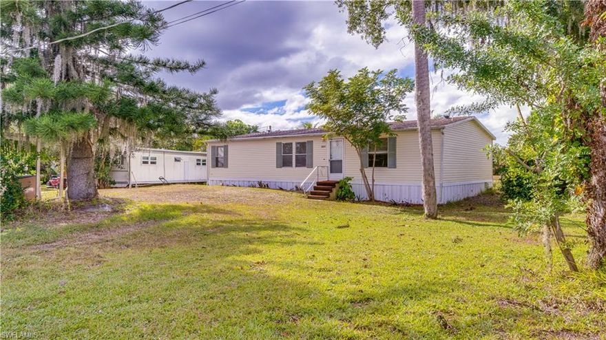 Affordable Gulf Access via the Caloosahatchee River! This 3-bedroom, 2-bath manufactured home offers an excellent opportunity to enjoy Gulf access via the Caloosahatchee River at an attainable price point. The split-bedroom layout and open floor plan provide functional living space suitable for full-time residence, seasonal enjoyment, or rental potential. The kitchen features a center island, ample cabinetry, and generous counter space, opening to the main living area. The primary bedroom suite includes a walk-in closet, walk-in shower, and a separate soaking tub. The roof was replaced in 2018. Outside, the spacious yard offers two carports and a storage shed, providing ample space for parking, storage, and outdoor gear. Whether you’re seeking a seasonal getaway, an investment property, or a home to personalize over time, this property delivers flexibility and valuable Gulf access.
