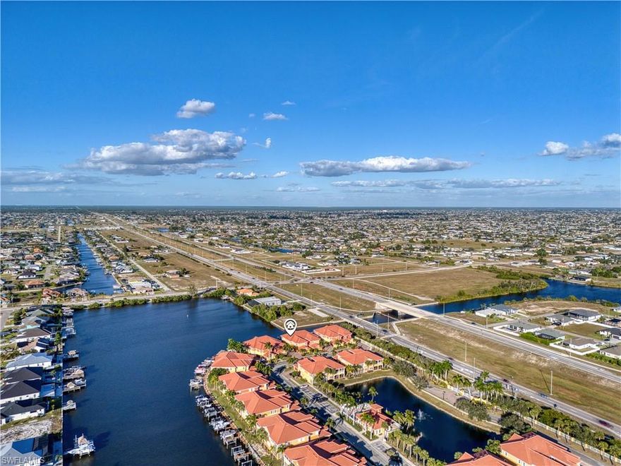 This Gulf Access Gem with Deeded Boat Dock is a MUST SEE. This 2nd Floor Corner Unit offers 3 Bedrooms plus Den, 2-5 Baths and a spacious 2-Car Garage nestled in Blue Water Coach Homes Community. The Building has been recently upgraded with New Roof, New Impact Windows and New Gutters giving you peace of mind. This unit comes with Private Dock, Deeded Boat Slip and 10000 LB Lift and provides fast access through Matlacha Pass to the Gulf and some of the best world class fishing in all of SW Florida. You’ll be welcomed by an expansive open-floor plan that effortlessly links the living, dining, and kitchen spaces. High end finishes abound – trey ceilings, crown molding, high-end laminate and tile flooring throughout. Additional conveniences include a dedicated laundry with large storage closet and a separate storage room you can use as pantry or additional storage. The gourmet kitchen features granite countertops, stainless steel appliances, and ample cabinetry, making it a dream home for any chef. Thoughtfully designed split floor plan with 10’ ceilings and 8’ doors include a formal dining room, breakfast nook, and bar seating. A fully equipped Wet Bar with Wine Refrigerator and Ice Maker is ideal for entertaining. Generous master suite boasts 2 walk-in closets and a lavish en-suite bathroom beautifully updated, upgraded and equipped with dual vanities, and large walk-in shower. You’ll never run out of room for guests with 2 additional bedrooms. Enjoy stunning canal views from your private screened lanai perfect for watching the Dolphins play or watching boats cruise by on the 20 minute excursion to open water. NO HOA FEE INCREASES PLANNED. Convenient to shopping, restaurants, airport and I-75. This is more than a home—it’s a lifestyle. Start living the dream of tropical waterfront living with minimal upkeep. This desirable waterfront community boasts resort-style amenities, including a sparkling pool, spa, fitness center, and TIKI hut. HOA fees equal $805 per month also include exterior insurance and flood insurance, and landscaping. Schedule your appointment today!