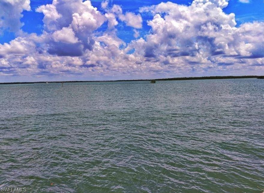 When views and location come together to offer a rarely available homesite on beautiful Marco Island. Enjoy wide water views and the evening lights on the S.S. Jolley Bridge from this premier tip lot with 230 feet of new rip-rap protected and reinforced seawall which affords spacious dock and waterfront deck opportunities. Marvel at the thousands of baitfish attracting larger marine life from the waterfront edge of this half acre lot. Save four months of time in planning and design when you work with one of Marco Island's top design and residential home construction companies with custom floor plans to capture the best panoramic views and maximizing the buildable potential for this direct Gulf access riverfront lot. Imagine your personal residence with 6500 square feet of living area with sunrise and sunset views. From your beautiful new home you catch fish from the private yard, enjoy water skiing or a jet ski, or travel to the 10,000 Islands for a day exploring and fishing. Minutes from the Marco Island Yacht Club and quick access to Collier Boulevard and Naples. Perfect for avid boaters and deep-water access to the Gulf of Mexico.