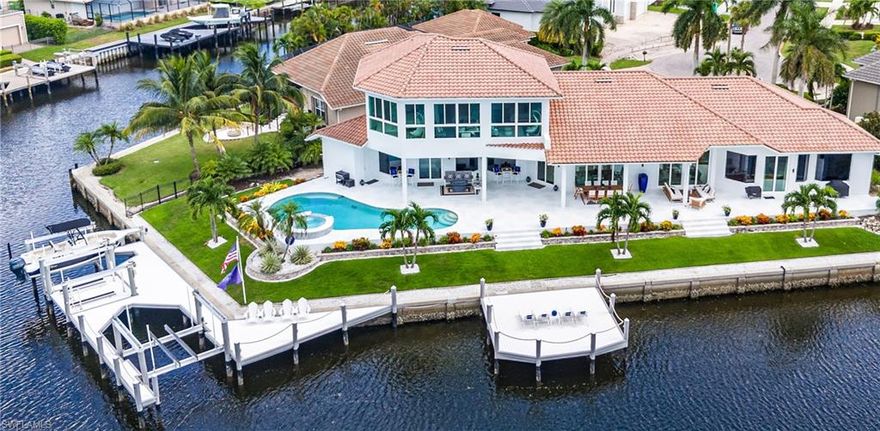 Experience waterfront luxury at its pinnacle! Twin Palms is a spectacular estate, set on a prized tip lot with 217 ft of water frontage. This breathtaking designer home was renovated and redesigned in 2022. You’ll entertain in style with an open-concept living space with soaring ceilings. Most rooms feature jaw-dropping views of the converging waterways. The gourmet kitchen features a center island, Wolf range and custom waterfront window seat. There is a linear fireplace and multiple sliders in the living room. The waterfront wet bar is a special place to celebrate life on Marco Island. The primary suite rivals a boutique hotel with beautiful views and custom walk-in closets. The bath is spa-like and boasts dual shower panels, a designer tub, and floating vanity.  A spacious first floor guest suite overlooks the glistening pool and features a custom closet and new bath. The remaining bedrooms are king-sized with oversized closets. The expansive lanai situated so you’ll enjoy both sunrises and sunsets. The saltwater pool and spa are sun-drenched. Boating enthusiasts will love the new dock featuring two lifts plus a Jet Ski platform. The new 24x24 sun deck perfect for soaking up the endless Marco sunshine. The lush landscaping wraps around the property like a private resort. Luxurious dolomite floors, an ice maker, Navian hot water heater and whole-house generator are just some of the special features of this estate. Designer furnishings are available. Twin Palms is a very special luxury property.