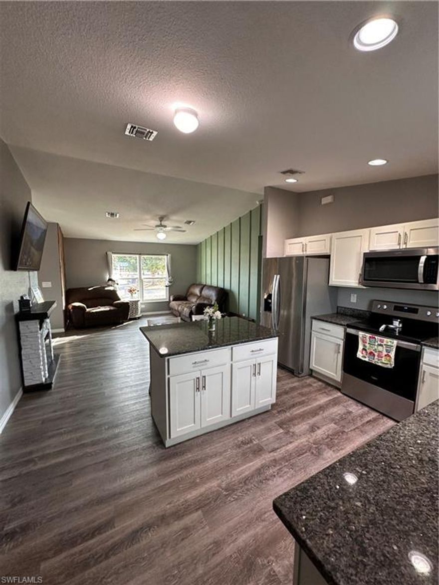 Welcome to Port Labelle - the quaint little river town with a real cowboy history! Why buy new when you can get a ONE YEAR WARRANTY and  so much more!  This lovely 3-bedroom, 2-bath home was built in 2020 and has been meticulously maintained by its original owners.  The 1,200 sq ft residence feels so much larger due to the desirable split open floor plan with soaring cathedral ceilings, creating a bright and inviting atmosphere. Custom wood accent walls throughout add warmth and a modern farmhouse touch.

The kitchen is both stylish and functional, offering abundant wood cabinetry, QUARTZ countertops, STAINLESS STEEL appliances, recessed lighting, and a center prep island with bar-stool seating. A convenient window and direct access to the backyard provide added security and peace of mind, allowing you to easily keep an eye on children at play while cooking. Two installed RING DOORBELLS and HURRICANE RATED WINDOWS AND DOORS  give an extra layer of convenience and security by allowing you to view visitors from phone whether you are at home or not. 

Durable gray wood-look vinyl tile flows through the main living areas, complemented by coordinating gray speckled carpet in the bedrooms. The INSIDE LAUNDRY room is ideally located just steps from the primary bedroom and includes a matching 2020 MAYTAG WASHER and DRYER. 

The private primary suite features a walk-in closet and an en-suite bathroom with a double vanity and walk-in shower. Additional highlights include an attached one-car garage with an INSTALLED AC SPLITTER  for comfort while working, two attic access points for extra storage, and upgraded flooring throughout.

Enjoy outdoor living in the FULLY FENCED backyard, complete with a wide front and rear gate ideal for RV or boat parking, plus a SHED for additional storage. Recent upgrades include gutters and soffits added to both the front and back of the home.

Conveniently located near a firehouse, police annex, Walmart, and a variety of great restaurants, with Labelle Middle School within view and walking distance.

SELLER IS OFFERING 8,000 TOWARDS BUYERS CLOSING COSTS WITH FULL PRICE OFFER making this move-in-ready home an exceptional opportunity.  Property is NOT in Flood zone.