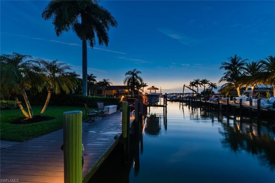 This modernized waterfront home is a Boaters dream! Relax in the shade under tall Royal Palms & enjoy breathtaking sunsets from your own backyard. Conveniently located just 2 doors from the open waters of Naples Bay. Nothing like a first impression with beautiful brick paved driveway & lush tropical landscaping. Enter into a completely renovated transitional coastal style home with an open floor plan & water views from every room. Kitchen upgrades include new quartz counter tops, custom cabinets, stainless steal appliances, beverage bar w/ ice-maker, etc. Other upgrades include bamboo wood flooring through-out, crown molding, hurricane impact resistant doors/windows, plantation shutters, etc. Incorporate indoor/outdoor living with pocketing hurricane sliders in every room. Back screened in patio offers a Cocktail Plunge Pool & lounge area for guests. Continue into your sizable back yard with towering Clusia Hedge offering complete privacy. Finally, step onto your custom wood dock where you can enjoy western sunsets or drop the boat from your 20,000 boat lift & take a night cruise. All of this located walking distance to downtown 5th Avenue & Naples white sandy beaches.