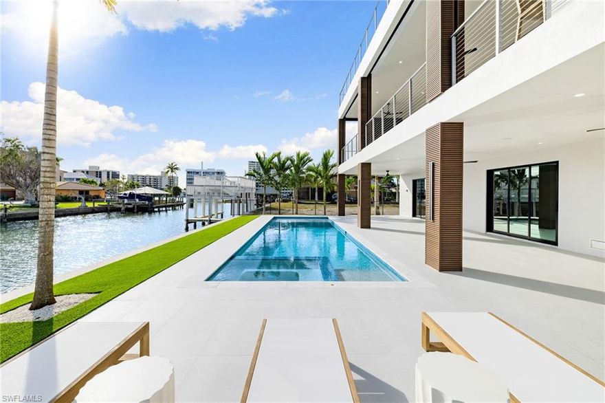 Introducing a NEW and FULLY FURNISHED Gulf-Access waterfront masterpiece located in one of Naples' premier and highly sought-after communities. Perfectly SOUTH-facing with breathtaking bay views and quick Gulf access, this luxury estate showcases impeccable craftsmanship by the distinguished Fox Premier Builders, a trusted local builder with 20+years of excellence. Designed and furnished to perfection, the home reflects architectural sophistication and the highest standards of modern coastal living.

Thoughtfully engineered with no detail overlooked, the property features a new 80’ seawall, saltwater pool and spa, elevated construction above base flood level, private elevator, whole-house generator prewire, home automation system, motorized bug and hurricane screens on main level deck for enhanced protection of outdoor living spaces. All impact-rated doors and windows ensure peace of mind and long-term durability.

Inside, the open-concept floor plan highlights a chef’s kitchen with custom cabinetry, quartz countertops, Sub-Zero and Wolf appliances, and a temperature-controlled wine room. The expansive great room offers a fireplace and an additional sitting area ideal for entertaining. Walls of sliding glass open seamlessly to the outdoor living terrace, where an upscale outdoor kitchen, dining space, and multiple lounging areas overlook wide-water vistas, evening sunsets, and partial Gulf views—creating an effortless indoor-outdoor lifestyle.

The residence offers 5 bedrooms and 4.5 baths, each designed with refined finishes and comfortable luxury in mind. Whether hosting guests, enjoying tranquil mornings by the bay, or taking the boat out for a waterfront lunch or sunset cruise, this home delivers the quintessential Florida lifestyle.

Perfectly situated just moments from Mercato (shopping and dining destination), Whole Foods, beachfront dining, Pelican Bay Community Park with brand new pickleball courts, and the Ritz-Carlton, this location blends serenity with unmatched convenience. Enjoy dramatic sunsets from your backyard or stroll to the white-sand beaches only blocks away. Private beach clubs such as La Playa Beach & Golf Resort, Ritz Carlton Beach Resort and the newly approved Paraiso are available to join and are under 5 minutes away. 

Seller is offering a $150,000 buyer credit toward the new dock with ready to go conceptual plans.