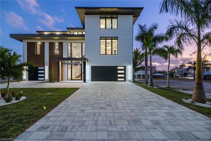 Introducing a newly built Gulf-access waterfront masterpiece located in one of Naples' premier and highly sought-after communities. Perfectly SOUTH-facing with breathtaking bay views and quick Gulf access, this luxury estate showcases impeccable craftsmanship by the distinguished Fox Premier Builders, a trusted local builder with 20+years of excellence. Designed and furnished to perfection, the home reflects architectural sophistication and the highest standards of modern coastal living.

Thoughtfully engineered with no detail overlooked, the property features a new 80’ seawall, saltwater pool and spa, elevated construction above base flood level, private elevator, whole-house generator prewire, home automation system, motorized bug and hurricane screens on main level deck for enhanced protection of outdoor living spaces. All impact-rated doors and windows ensure peace of mind and long-term durability.

Inside, the open-concept floor plan highlights a chef’s kitchen with custom cabinetry, quartz countertops, Sub-Zero and Wolf appliances, and a temperature-controlled wine room. The expansive great room offers a fireplace and an additional sitting area ideal for entertaining. Walls of sliding glass open seamlessly to the outdoor living terrace, where an upscale outdoor kitchen, dining space, and multiple lounging areas overlook wide-water vistas, evening sunsets, and partial Gulf views—creating an effortless indoor-outdoor lifestyle.

The residence offers 5 bedrooms and 4.5 baths, each designed with refined finishes and comfortable luxury in mind. Whether hosting guests, enjoying tranquil mornings by the bay, or taking the boat out for a waterfront lunch or sunset cruise, this home delivers the quintessential Florida lifestyle.

Perfectly situated just moments from Mercato (shopping and dining destination), Whole Foods, beachfront dining, Pelican Bay Community Park with brand new pickleball courts, and the Ritz-Carlton, this location blends serenity with unmatched convenience. Enjoy dramatic sunsets from your backyard or stroll to the white-sand beaches only blocks away.

Seller is offering a $150,000 buyer credit toward the new dock with ready to go conceptual plans.