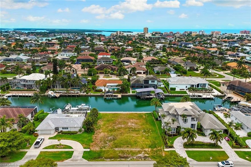 This oversized direct access waterfront lot presents a rare opportunity to build a signature custom residence in one of Marco Island’s most desirable locations. Offering 100 feet of waterfrontage and ideal southern exposure, the lot is positioned to capture all-day sun and support a thoughtfully designed indoor-outdoor lifestyle. Boating enthusiasts will appreciate the convenience of direct Gulf access, with a quick route to open water through nearby Caxambas Pass—no bridges. Whether you envision a private dock or an expansive outdoor living space, the generous dimensions and orientation of the lot provide flexibility to bring your vision to life. The location also delivers when it comes to daily convenience and lifestyle. Just minutes from Winterberry Beach Access and Marco Walk Plaza, you’ll enjoy easy proximity to the island’s premier dining, boutique shopping, movie theater, and recreation, all in a short distance of your future front door. This parcel blends premium location, waterfront access and size, a combination rarely available in today’s market. Whether you’re looking to build a primary residence or a luxury vacation home, this is the foundation to create something exceptional on Marco Island.