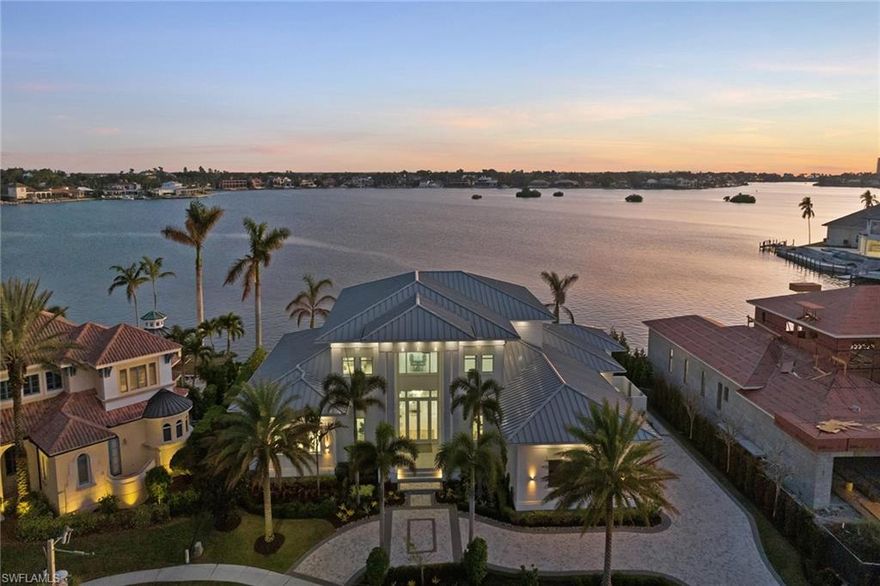 Absolutely breathtaking contemporary home with wide-open southern bay views in the Estates area! Built in 2020, this jaw-dropping, detailed home has left no expenses spared and nothing left out. Over 6,500 SF under air and a total of 9,377 SF, this incredible home is truly a dream come true! Quartz and quartzite counters throughout, white oak flooring throughout as well as Statuario polished marble on great room wall, indoor and outdoor fireplace and icy blue leather finish quartzite on outdoor kitchen. Incredible kitchen overlooking bay and Gulf with Wolf and Viking appliances, quartz counters and drop-down ceilings. Floating steel frame stringer staircase with oak-finished wood and glass balusters. Incredible pool area with fire pits, outdoor kitchen complete with outdoor pool bath and sauna. Upstairs media room boasts wet bar, game room and upstairs lanai. 5 bedrooms, 5 full and 2 half baths, den, media room and game room. 3-story elevator and 20-foot air-conditioned 4-car garage with room for lift. Beyond impressive this home is built for the most discerning buyer, and will not disappoint! Being sold furnished for your convenience.