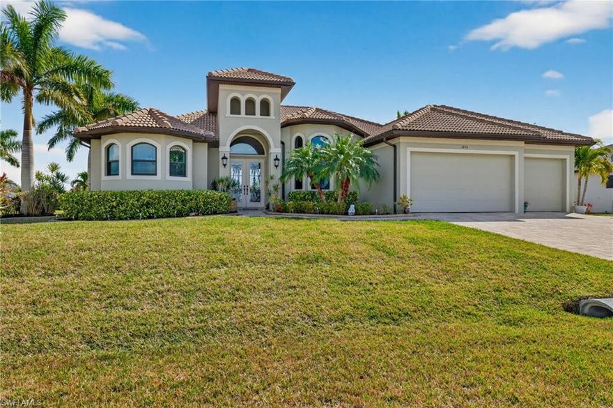 EXPECT TO BE ENVIED! TURNKEY FURNISHED CUSTOM BUILT WATERFRONT POOL & SPA HOME WITH 3 CAR GARAGE ON 4 LOT SITE IN BEAUTIFUL CAPE CORAL. NO FLOOD ZONE! 3 bedroom + den home boasts so many upgraded features starting with 2 primary bedroom suites, large kitchen w/ separate dining area, granite counters, 42" wood cabinetry w/ soft close drawers & doors. Custom master bathroom has separate shower & tub, dual sinks, & large walk in his/her closets. High 14 ft. tray ceiling in living area w/ 12 ft tray ceilings in bedrooms, tile flooring throughout, 10ft sliding doors to pool, HURRICANE IMPACT windows & doors, crown molding throughout,14 speaker sound system & entire home water treatment system. Garage has epoxy flooring. Massive lanai is perfect for sunbathing, relaxing & entertaining! New summer kitchen just added to pool area.  Inside touch screen controls all pool & spa functions. Pool bath, separate pool storage closet, electric lanai storm screen & new pool cage super screening are added features. Meticulously landscaped 4 lot property gives extra privacy & intersecting canal view! Upgraded brick pavered driveway, entryway & walkways. Well is 220 feet deep, seawall w/ dock is 160 ft long. Cruise down the 150 ft wide canal & enjoy fishing,scenery, & relaxation. Remember to view the video.