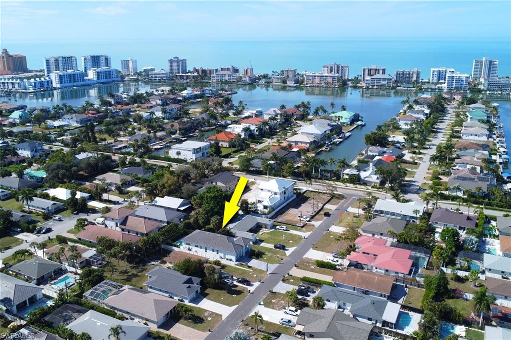 Aerial view of Naples Park, showcasing residential properties and proximity to water bodies, highlighting the location of the luxury home for sale at 522 98th AVE N, near Vanderbilt Beach.