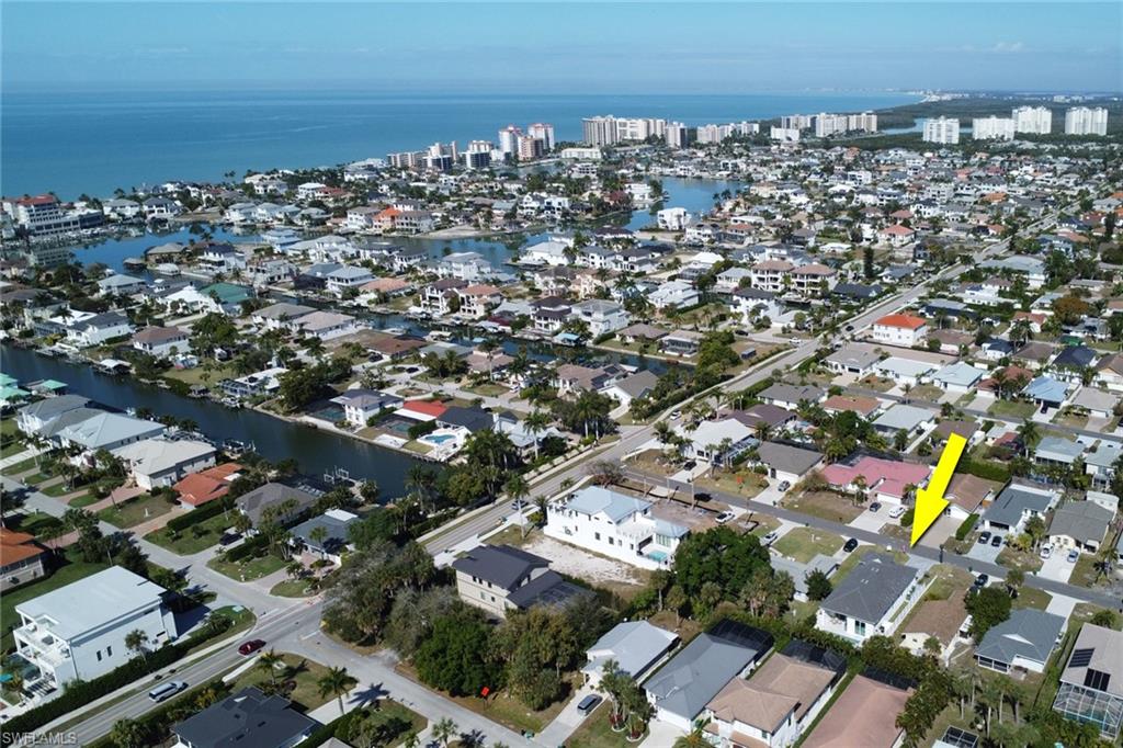 Aerial view of Naples Park, showcasing residential properties and proximity to the coast, highlighting the luxury home for sale at 522 98th AVE N, near Vanderbilt Beach.