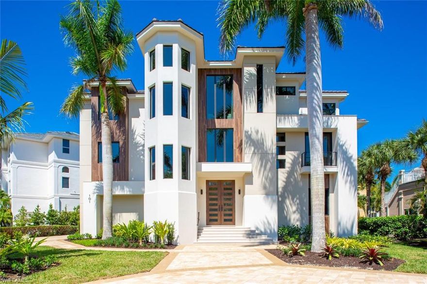 BEACHFRONT MASTERPIECE IN NORTH NAPLES’ “BAREFOOT BEACH,” FULLY RE-ENGINEERED WITH ULTRA-RARE BRAND-NEW PRIVATE POOL… Over the last 10 years in Barefoot Beach there has been only ONE beachside home sold with a private pool, this an elevated infinity edge pool/spa with outdoor kitchen! JUST COMPLETED IN 2020, this 5700+ sq ft architectural wonder was re-engineered down to the concrete shell & re-built by awardwinning Potter Homes & designed by coveted Freestyle Interiors**. The rare double lot allows for an extra wide-open floor plan, accented by oversized galleries of glass for extra light & maximum Gulf views. From the luxe maple wood floors, soaring ceilings with uplit wood panel accents & quartzite/granite counters throughout, to the custom cabinetry in warm tones with modern chromatic accents, this one-of-a-kind home will impress the most discerning buyer. Professional chef’s kitchen includes Thermador appliances & floor to ceiling custom cabinetry with waterfall quartz island. This newly rebuilt home includes all new impact glass doors/windows, new concrete tile roof, new HVAC & smart home technology with iPad-controlled climate, Lutron light system & surround sound.