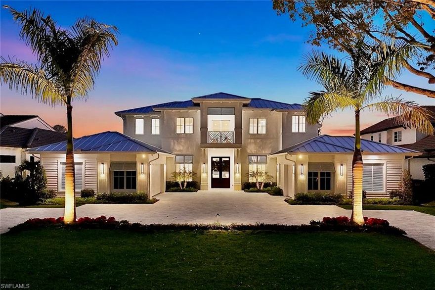Timeless, elegant design, superior craftsmanship, and a light-filled southern exposure come together seamlessly in this stunning 5 bedroom plus den, new construction Moorings home, ready to be enjoyed this season. Located on  Riviera Drive with its gorgeous tree-lined canopy, and built by Dillman Construction, one of Naples’ premier luxury builders, the expansive two-story floor plan offers exceptional living and entertaining opportunities, featuring both downstairs and upstairs living areas along with beautiful outdoor patios and terraces on each level. The spacious primary suite is a relaxing haven, complete with a spa-inspired bathroom, while 2 further bedroom suites on the main level and two additional suites upstairs provide generous accommodations for family and guests.

The interior reflects refined luxury throughout, highlighted by extensive custom woodwork and wainscoting and Legno Bastone oak flooring that enhance the home’s elegance. The chef’s kitchen is outfitted with Sub-Zero and Wolf appliances and includes a concealed walk-in pantry with custom cabinetry perfect as a coffee/beverage bar. Other features include an elevator, whole-house generator, two linear fireplaces, a Lutron lighting system, and spacious garages with air-conditioned storage.  Outdoors, the spectacular south facing grounds showcase a 40-foot lap pool with waterfall and spa, multiple fire features, and an expansive outdoor living area with linear fireplace and kitchen.  An outdoor shower, and electric screens and shutters complete the experience. All of this is complemented by beautifully landscaped, private grounds that offer tranquil views from every room. Private beach access with parking is available through the Moorings Property Owners Association for a nominal fee.