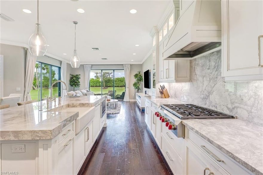 This spectacular one of a kind Shiraz sits on huge oversized lot on a quiet cul-de-sac. It features hurricane impact windows in the front of the home. The gourmet chef's kitchen features 72 inch custom soft close cabinets.  SUBZERO 60" BUILT-IN REFRIGERAT0R AND 180 BOTTLE WINE COOLER.  WOLF DOUBLE CONVECTION OVEN AND WOLF PROFESSIONAL 6 BURNER GAS RANGE.  KOHLER CAST IRON FARMERS SINK, BUILT-IN CABINET COVERED DISHWASHER, MICROWAVE AND STORAGE.  SUPER WHITE MARBLE COUNTERTOPS & BACKSPLASH. Added storage above refrigerators and the Island. Marble throughout the home including:  Office, mud room, laundry room, fireplace, wet bar. Custom crown molding, and wainscoting. Designer lighting and furnishings. Hardwood flooring throughout and beautiful wrought iron and wood staircase.  Custom garage with rectified tile flooring, tons of cabinets and overhead storage.  Abundance of added storage throughout the home. Professionally designed laundry room with custom cabinets, beautiful faucets and knobs, built in hamper drawers, and pull out ironing board.