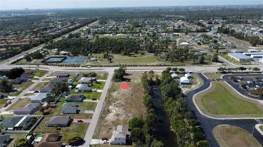 Within WALKING DISTANCE to the new Gator Trails Park, you'll find this wonderful residential building lot with water frontage on Scotty's Canal.  *This is a NON-FLOOD zone, and the western rear exposure will provide a beautiful skyline when the sun sets each evening!  *The brand new ALDI's grocery store recently opened, and you are just minutes away.  *With Island Coast High School right around the corner, your children can skip the bus stop along with early morning school bus pickups and WALK to school! *Join this active, growing, neighborhood when you build your new home.  *Opportunity waits for kayaking, boating, and birdwatching from your own backyard, and the Florida lifestyle can be yours too!