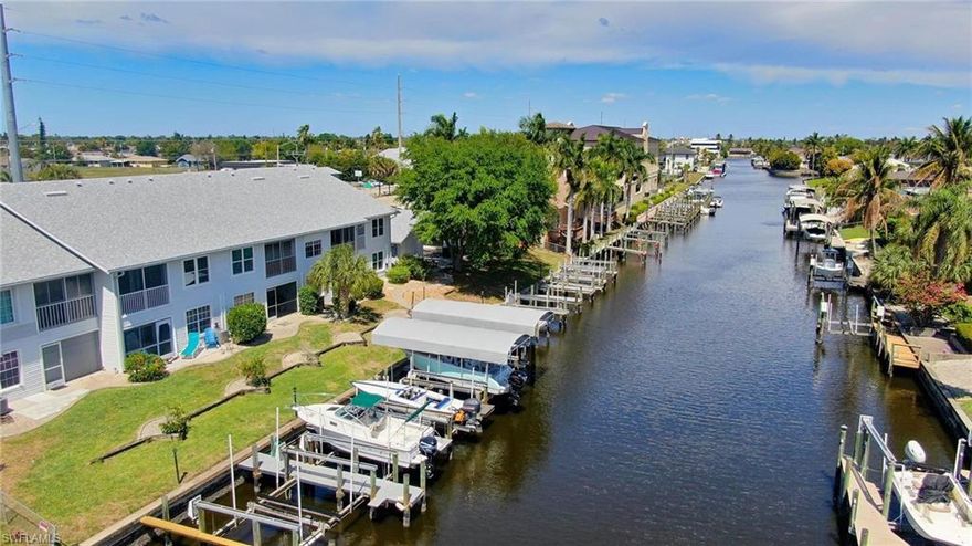 Experience effortless waterfront living in this beautifully maintained 2-bedroom, 2-bath second-floor condo offering direct Gulf access with NO BRIDGES AND NO FLOOD ZONE—a true boater’s dream. This canal-front residence includes a covered boat slip with a 7,000 lb lift, featuring recently replaced motors, so you can get out on the water with ease and confidence.

Inside, you’ll find an inviting open floor plan with tile flooring throughout, creating a seamless and low-maintenance living space. The spacious kitchen is equipped with stainless steel appliances, granite countertops, and flows effortlessly into the dining and living areas—perfect for entertaining or relaxing.

The primary suite offers comfort and privacy, while the guest bedroom includes private access to the bathroom, making it ideal for visitors. An in-unit washer and dryer add everyday convenience.

Enjoy the water view and see your boat right from your living area! Additional highlights include an assigned covered carport, extra storage space, and the added peace of mind of being located in a no flood zone.

Recent upgrades enhance both value and reliability, including new PEX piping, a newer HVAC system and hot water heater, impact-resistant windows, and a roof replaced in 2023.

Whether you're seeking a seasonal retreat or a full-time residence, this condo delivers the perfect blend of comfort, convenience, and premier waterfront access.